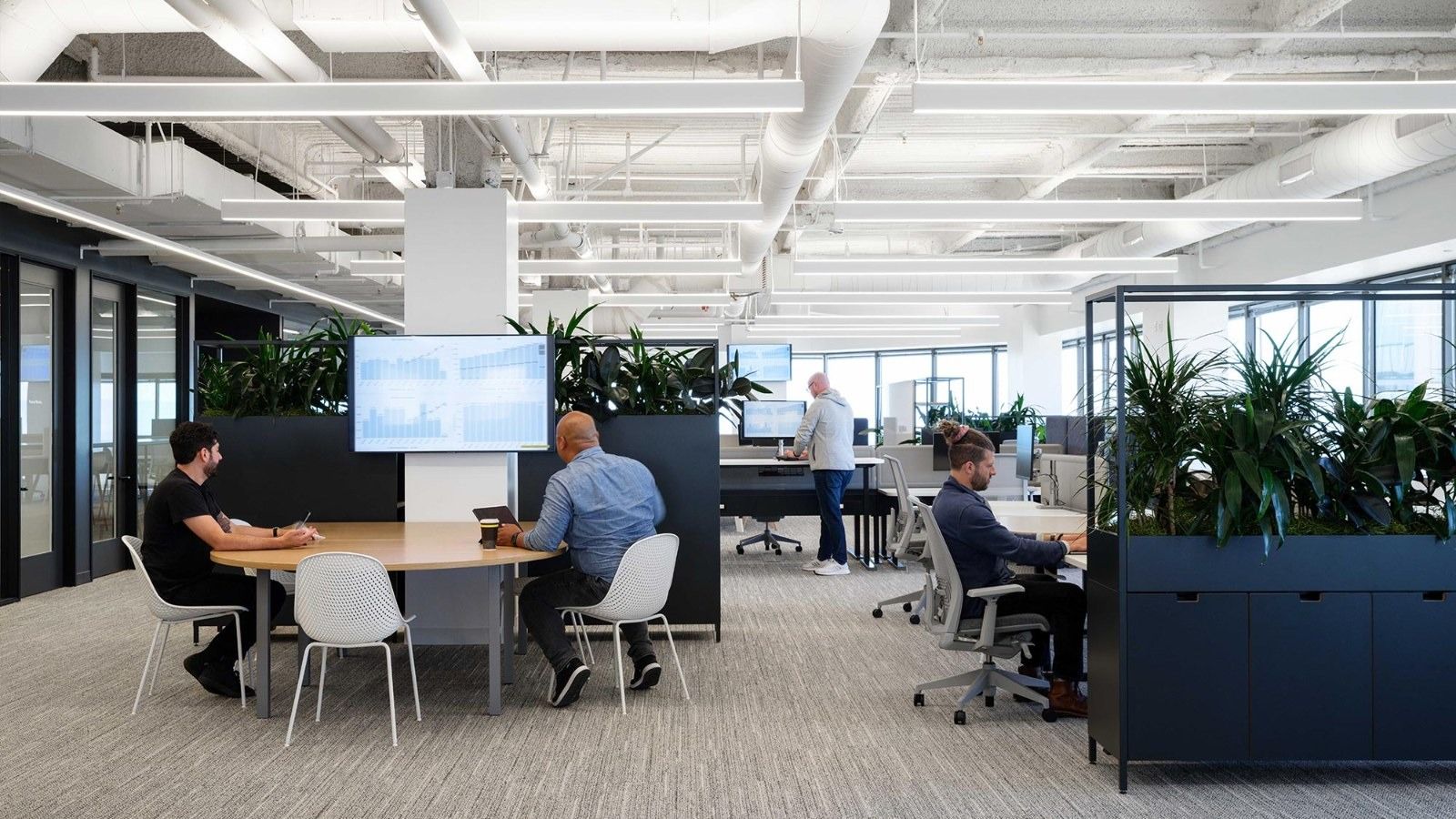 Fivetran: Desks and planters under an open ceiling