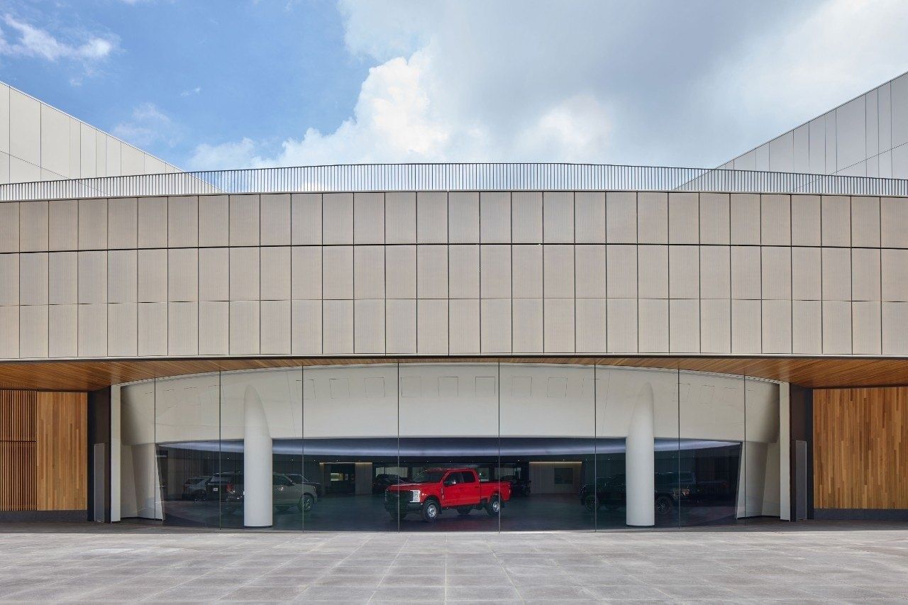 Ford Motor Company: Entrance with a red truck behind glass
