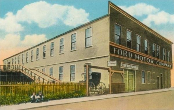 Postcard of a two-storey plant with a Ford Motor Company sign