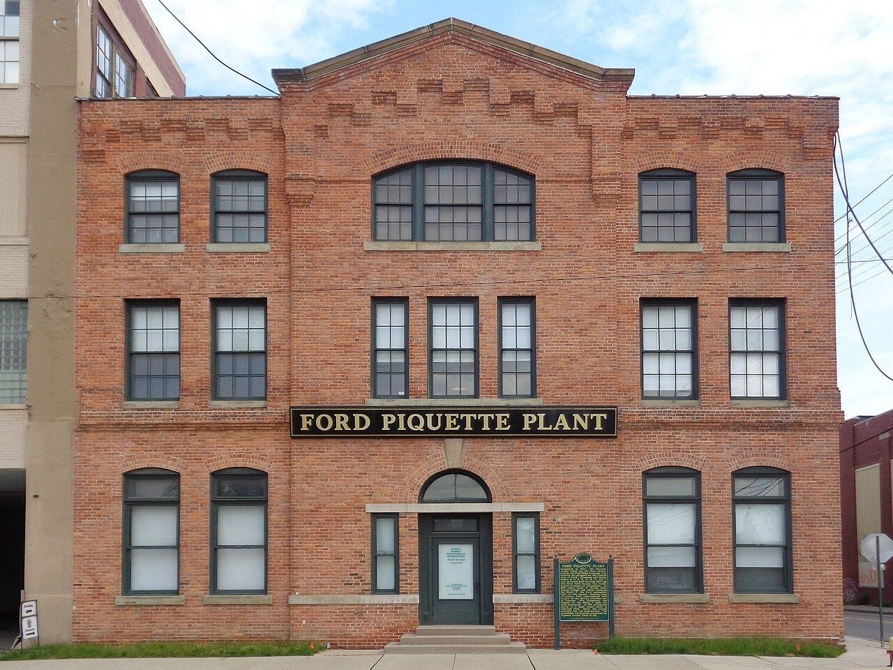 Three-storey brick plant with a Ford Piquette Plant sign