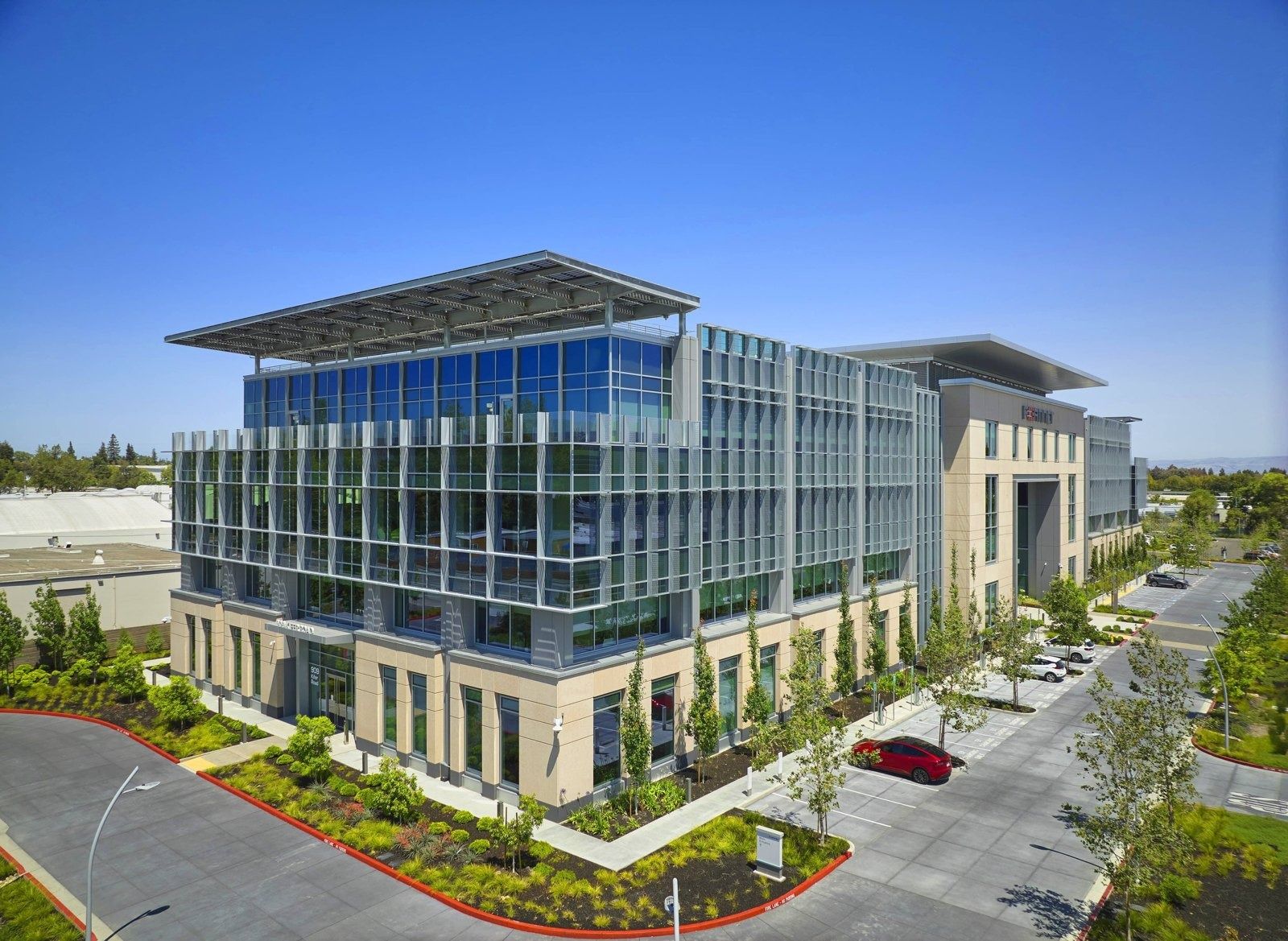 Fortinet: Elevated view of the building with planted parking areas and surrounding trees