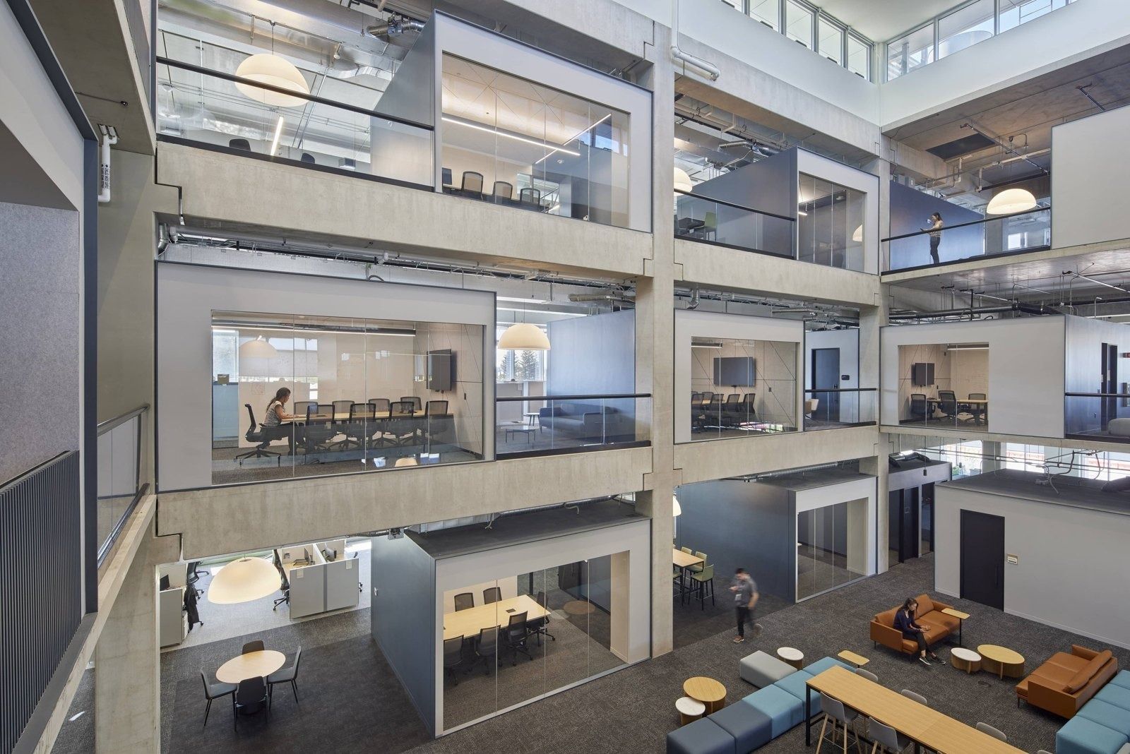 Fortinet: Multi-level interior atrium ringed by glass-walled meeting rooms above a lounge with sofas and tables