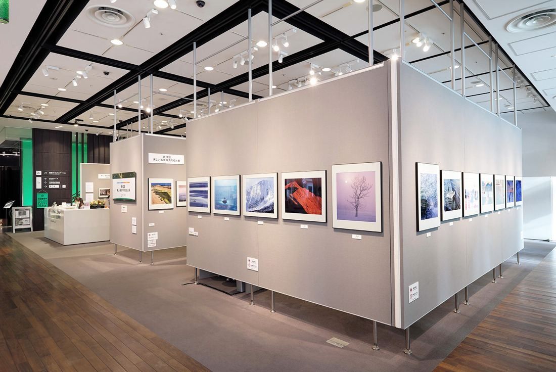 Fujifilm: Bright gallery with grey freestanding walls hung with framed photographs