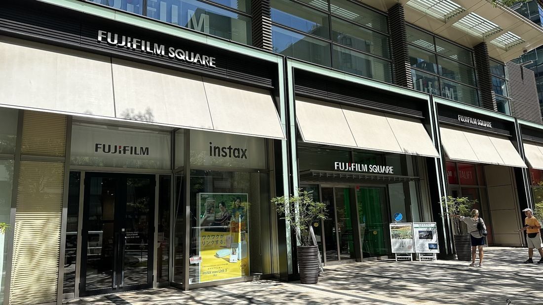 Fujifilm: Street-level shopfronts under awnings with Fujifilm and instax signs