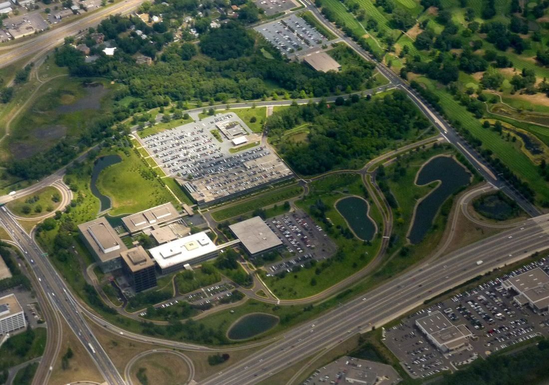 General Mills: Aerial view of a low-rise office campus with parking, ponds and woodland
