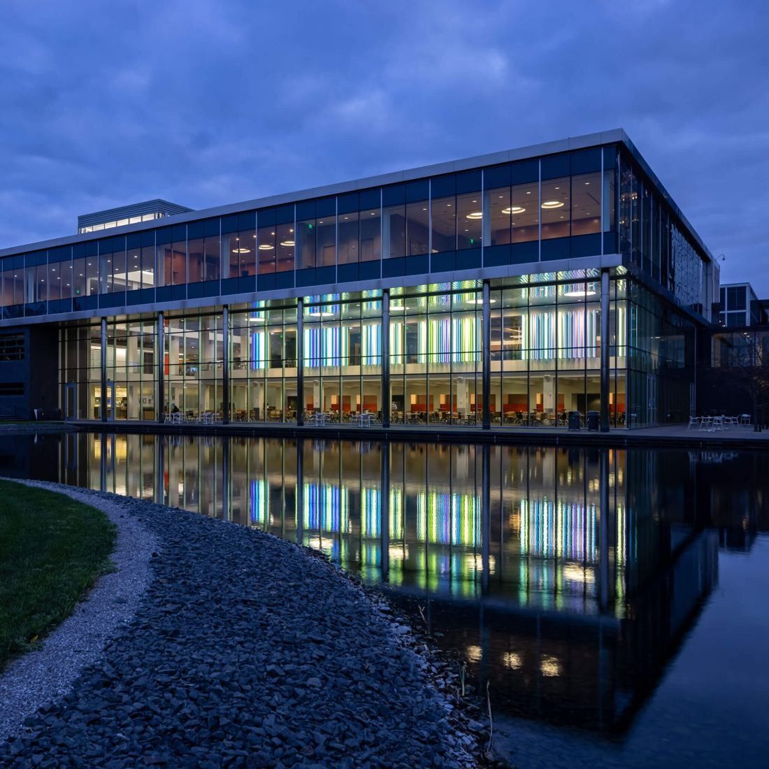 General Mills: Glass-walled building lit at dusk, reflected in a pond