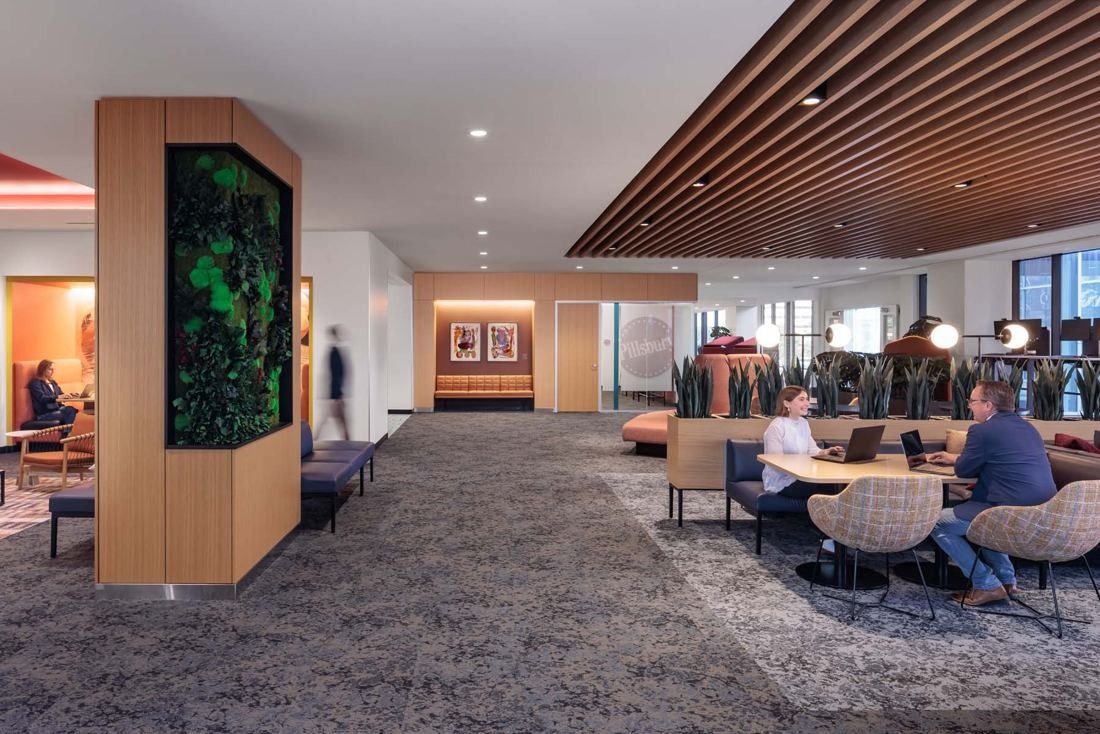 General Mills: Open office floor with a moss-covered column, wood-slat ceiling and booth seating