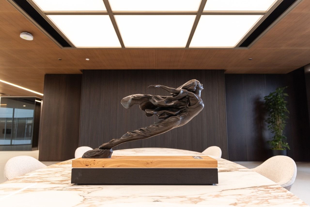 General Motors: Bronze Cadillac Goddess sculpture on a table