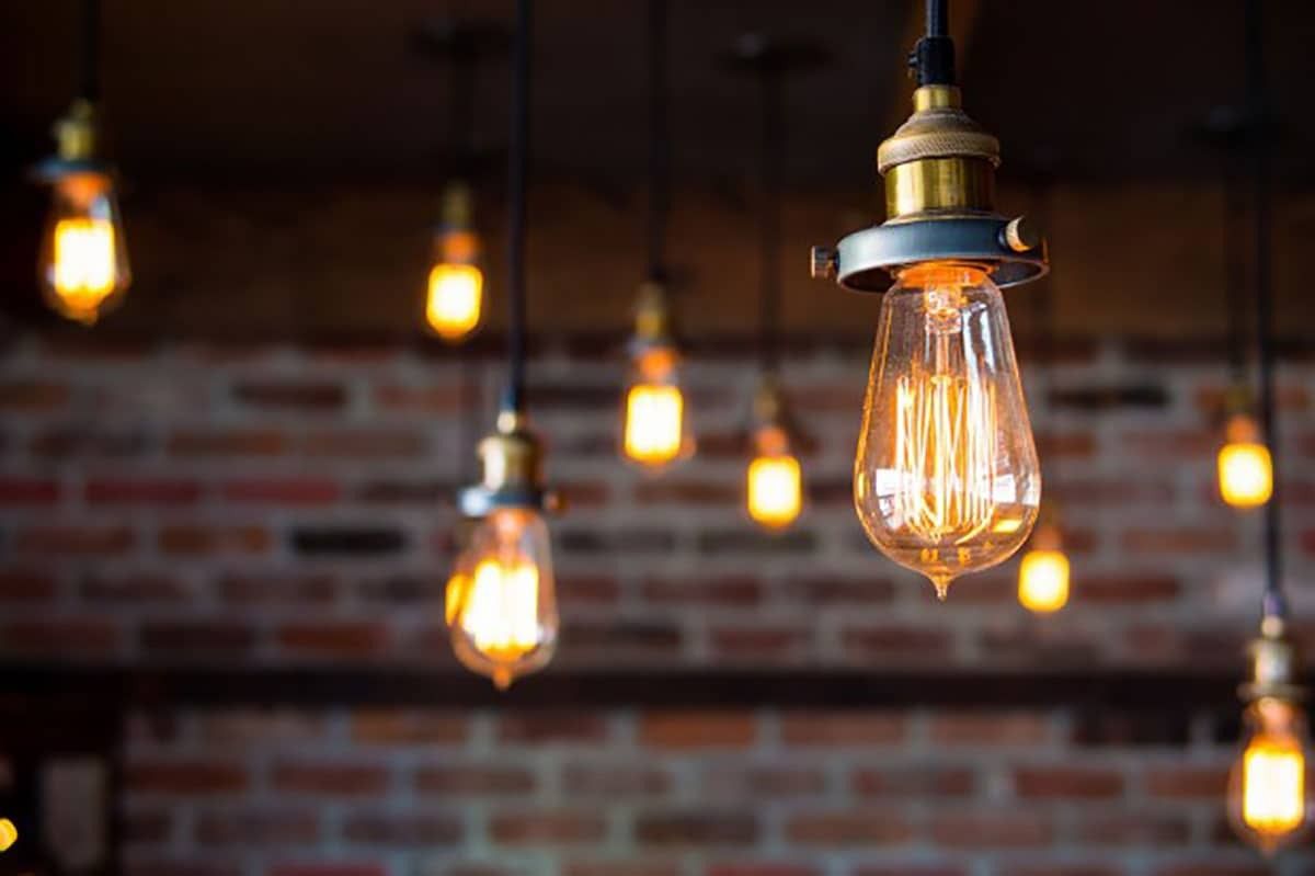 GitHub: Bare filament bulbs in front of a brick wall