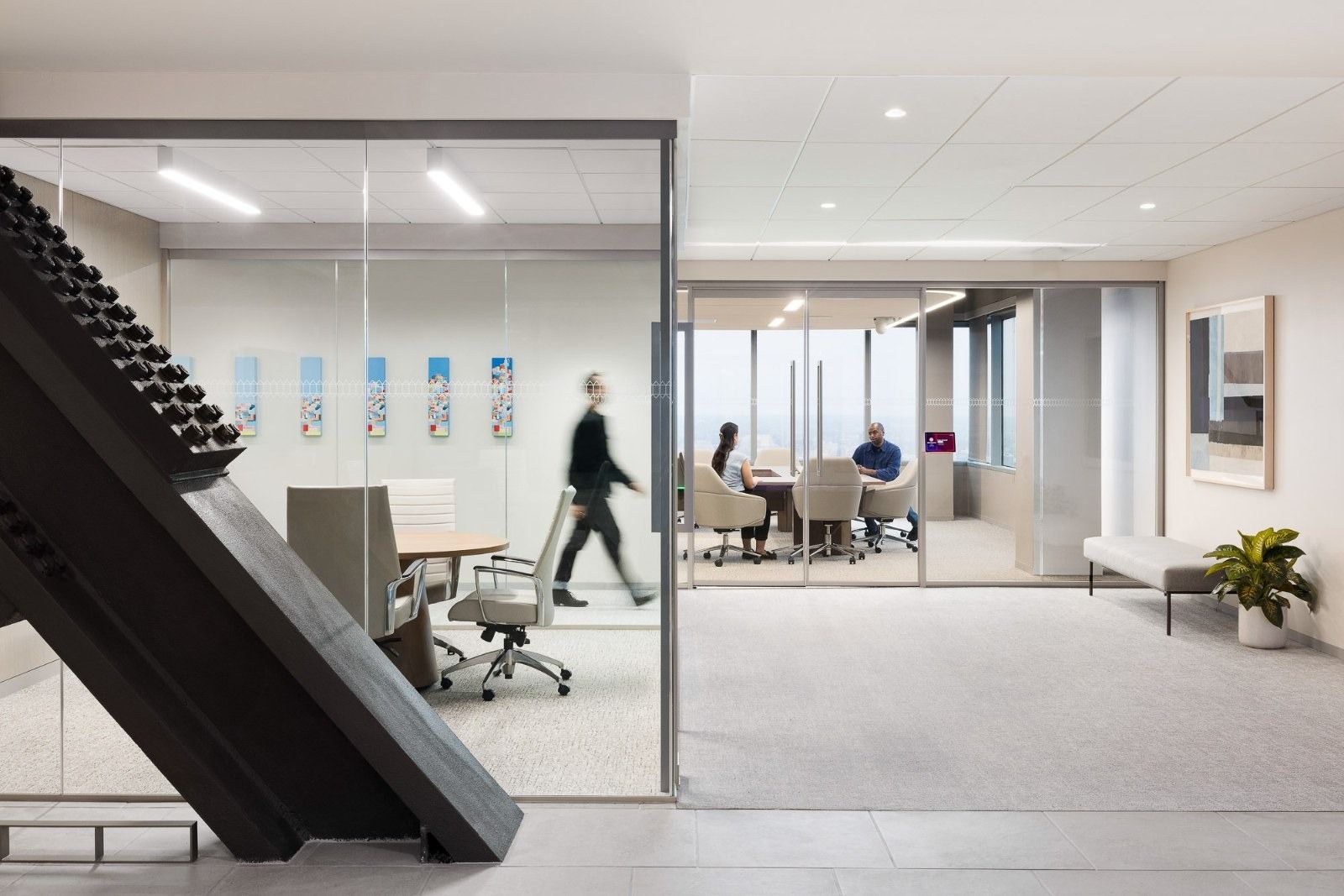 Glenmede: A black stair beside glass meeting rooms