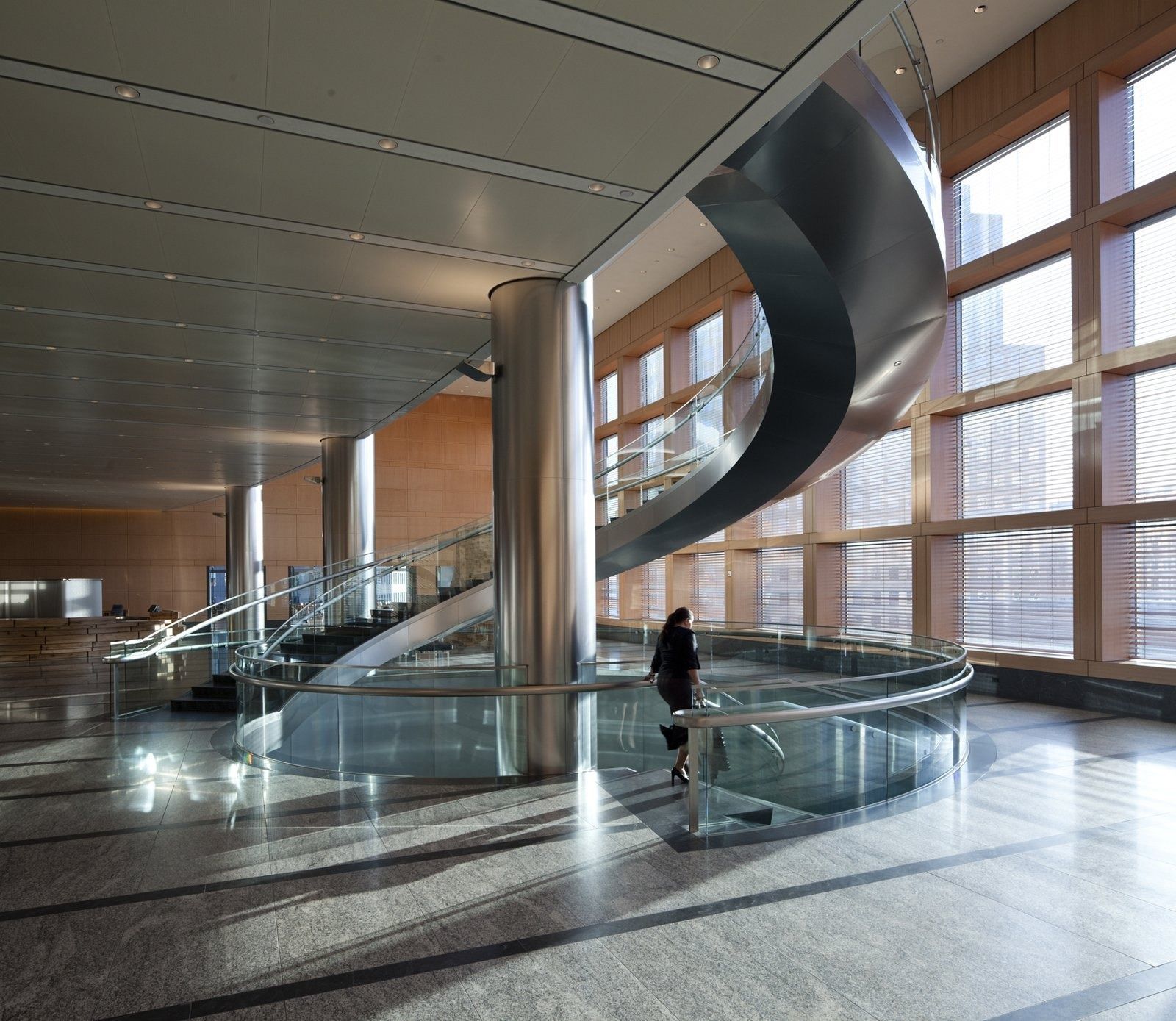 Goldman Sachs: A sweeping spiral stair in the double-height sky lobby with river views