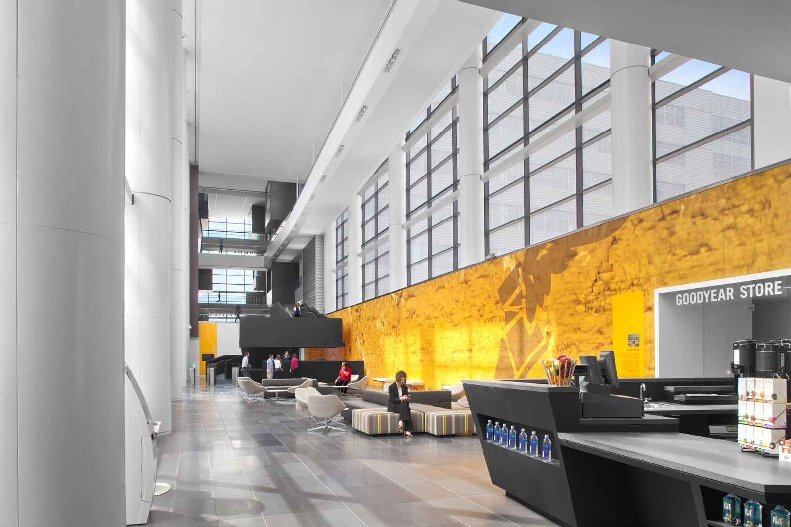 Goodyear: A tall atrium with a golden wall and a reception desk