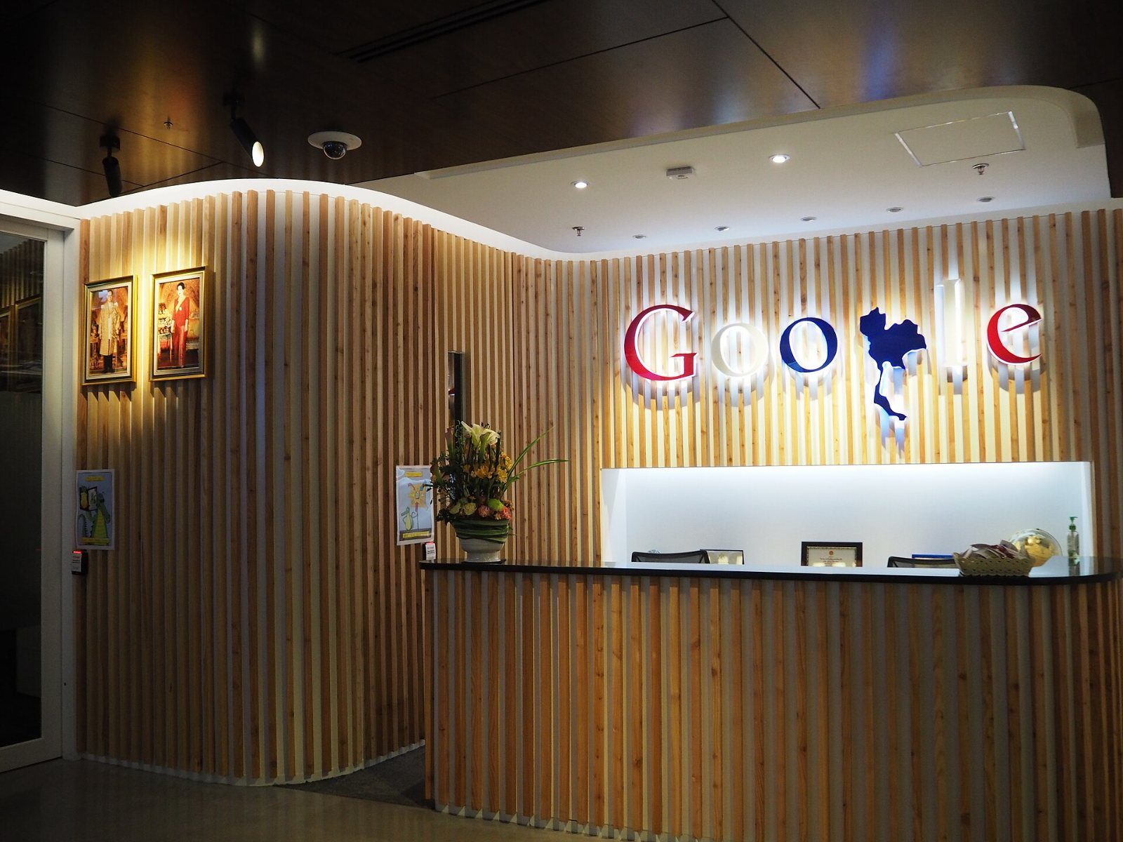 Google: Wooden reception desk with a Google logo