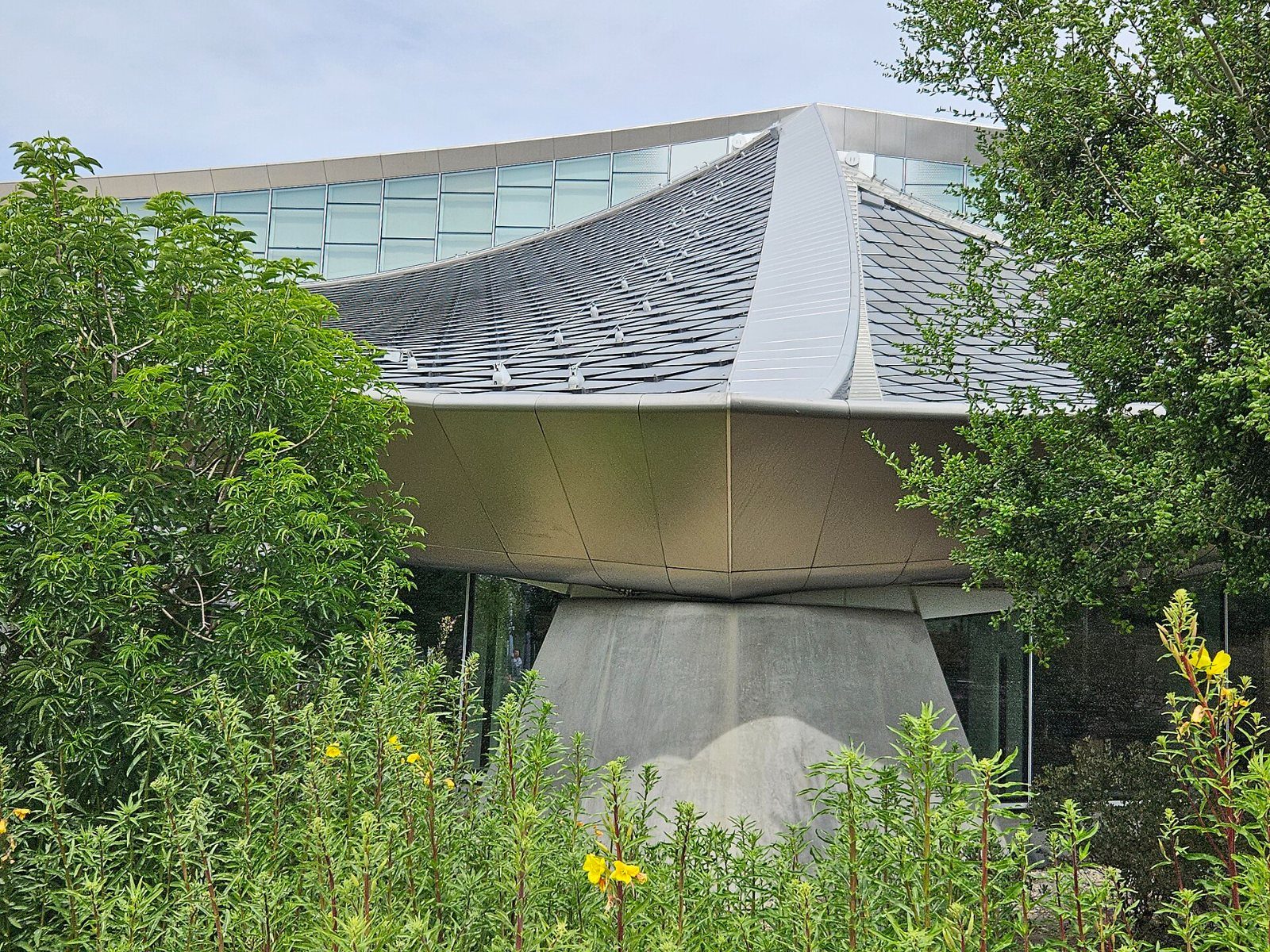 Google: Building with an angled roof behind trees