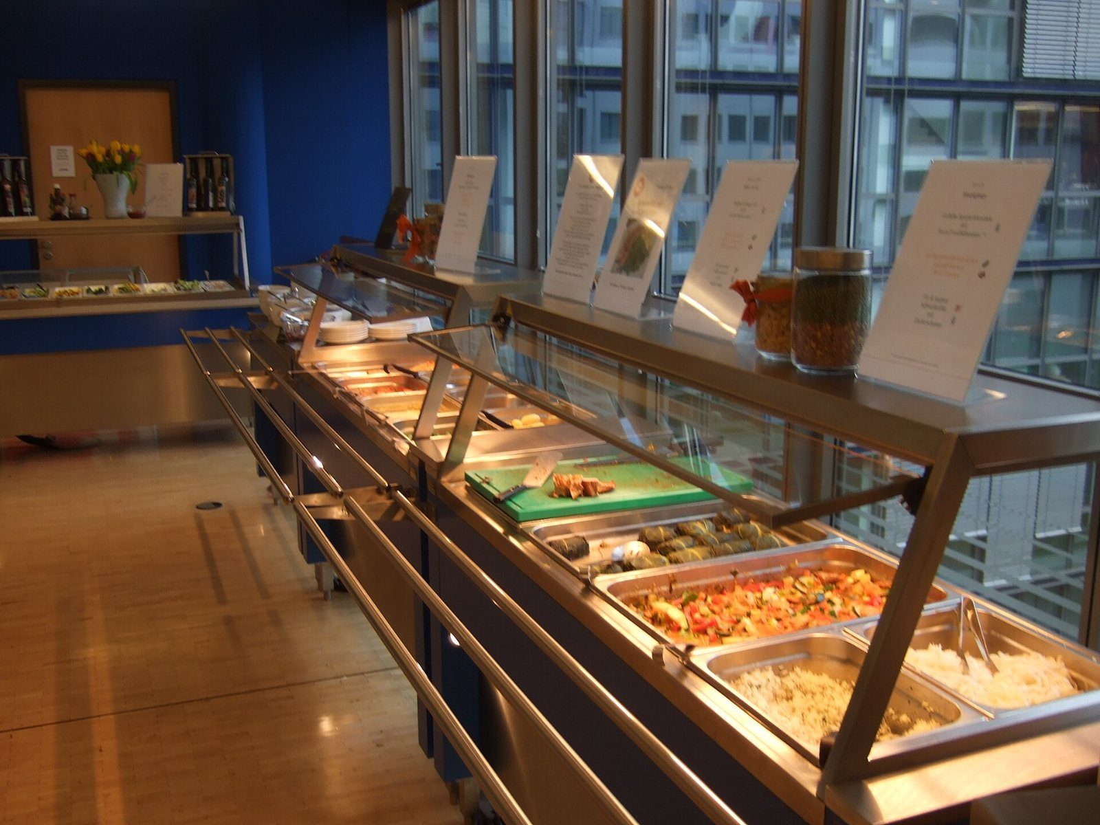 Google: Food counter with trays of dishes