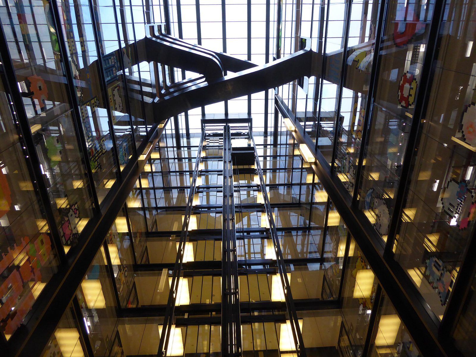 Google: Looking up through a tall atrium of crossing stairs