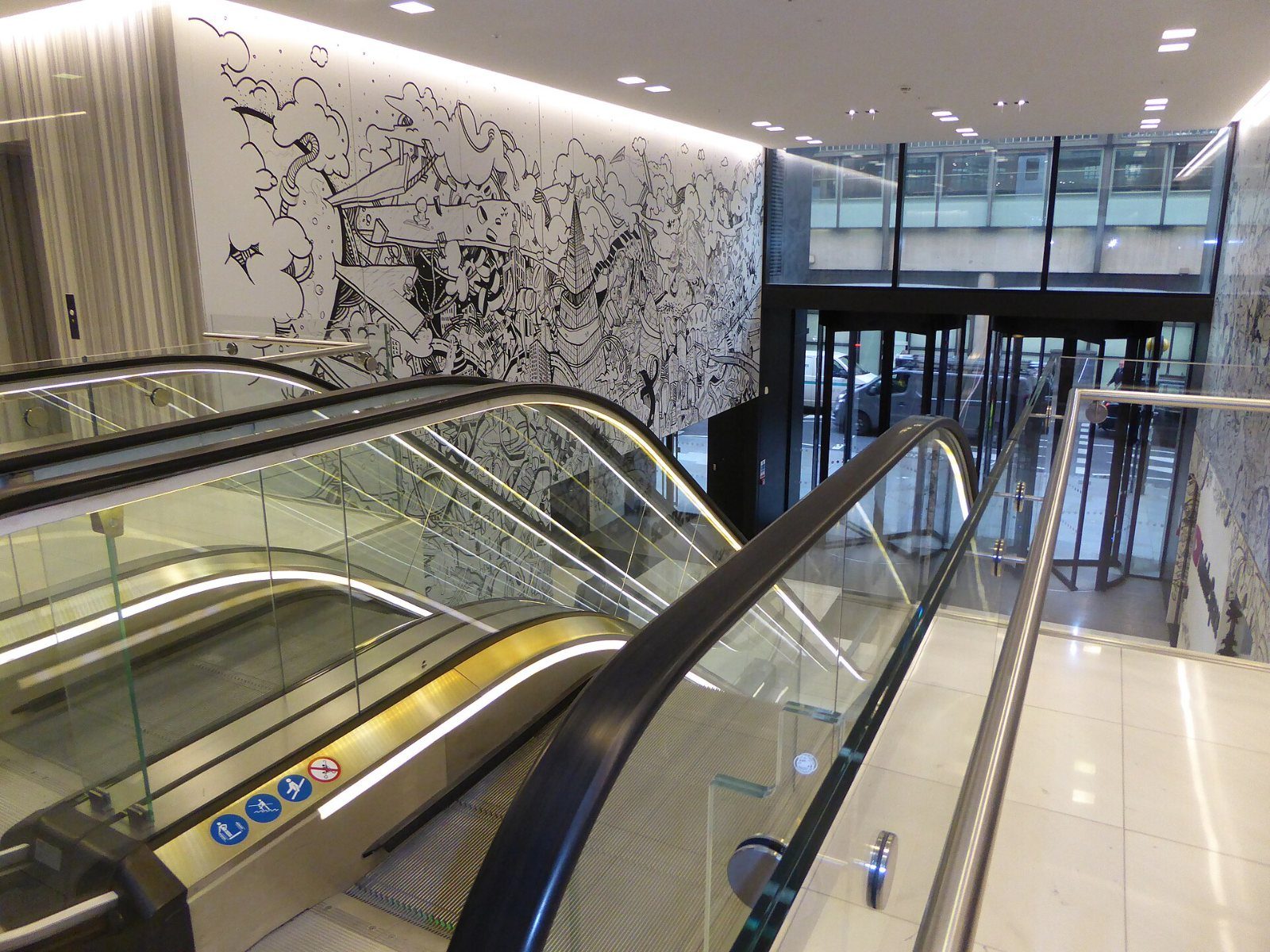 Google: Escalators beside a large drawn mural