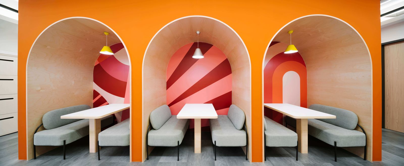 Grab: Arched orange booths with red and white striped backs