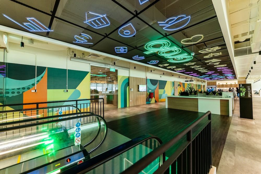 Grab: Escalator and colourful walls under neon lights