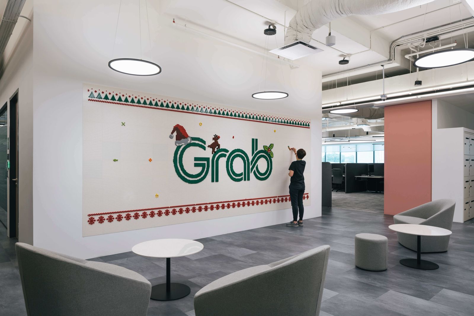 Grab: Large Grab lettering on a white wall in a lounge