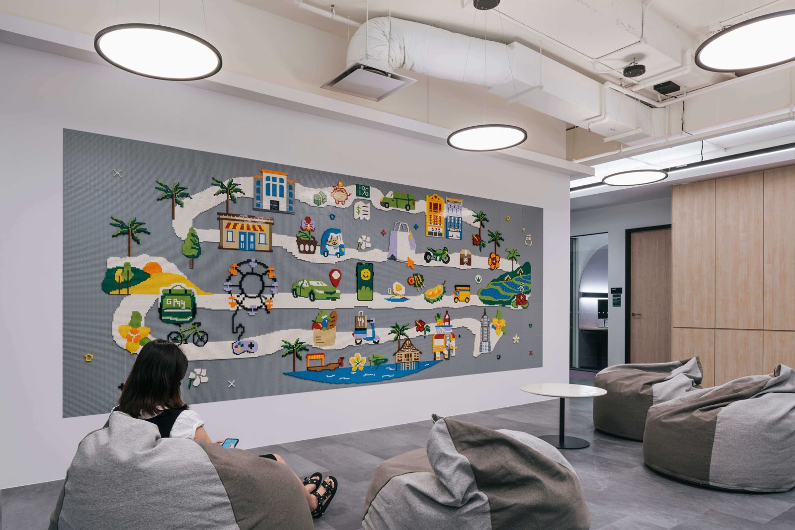 Grab: Lounge with bean bags in front of an illustrated wall map