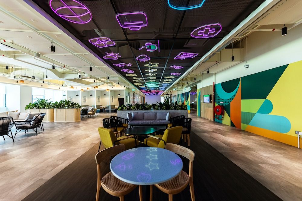 Grab: Open floor under a ceiling of neon food-shaped lights
