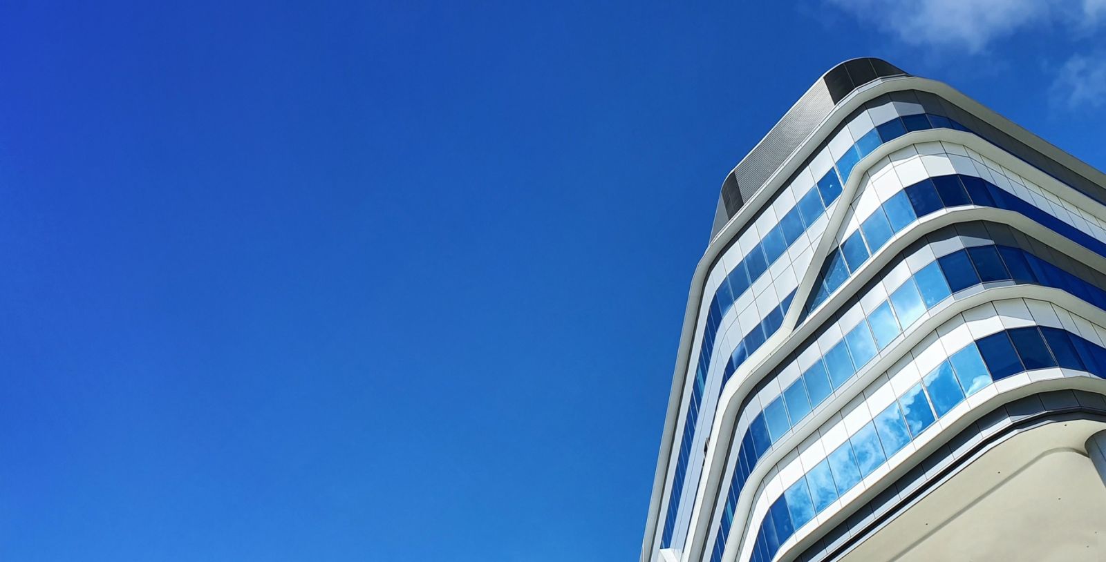 Grab: Rounded corner of the tower against blue sky