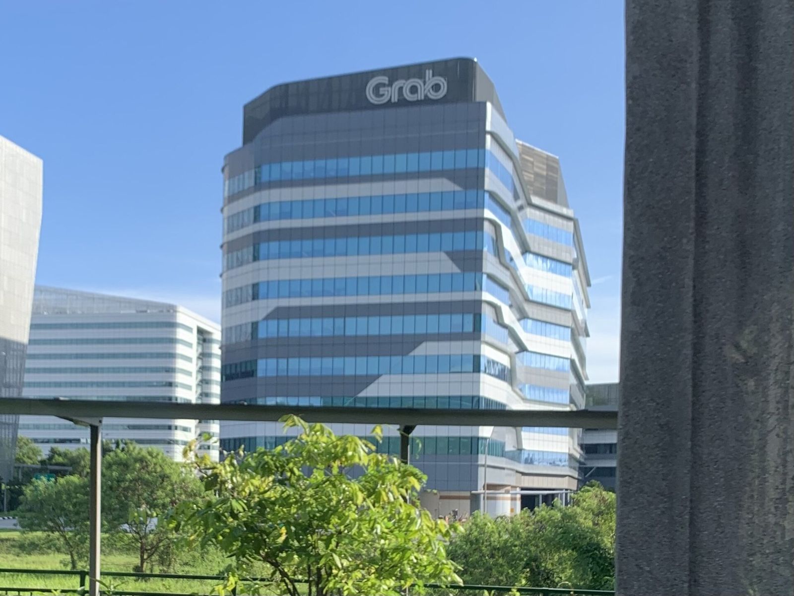 Grab: The taller tower with the Grab sign on its crown