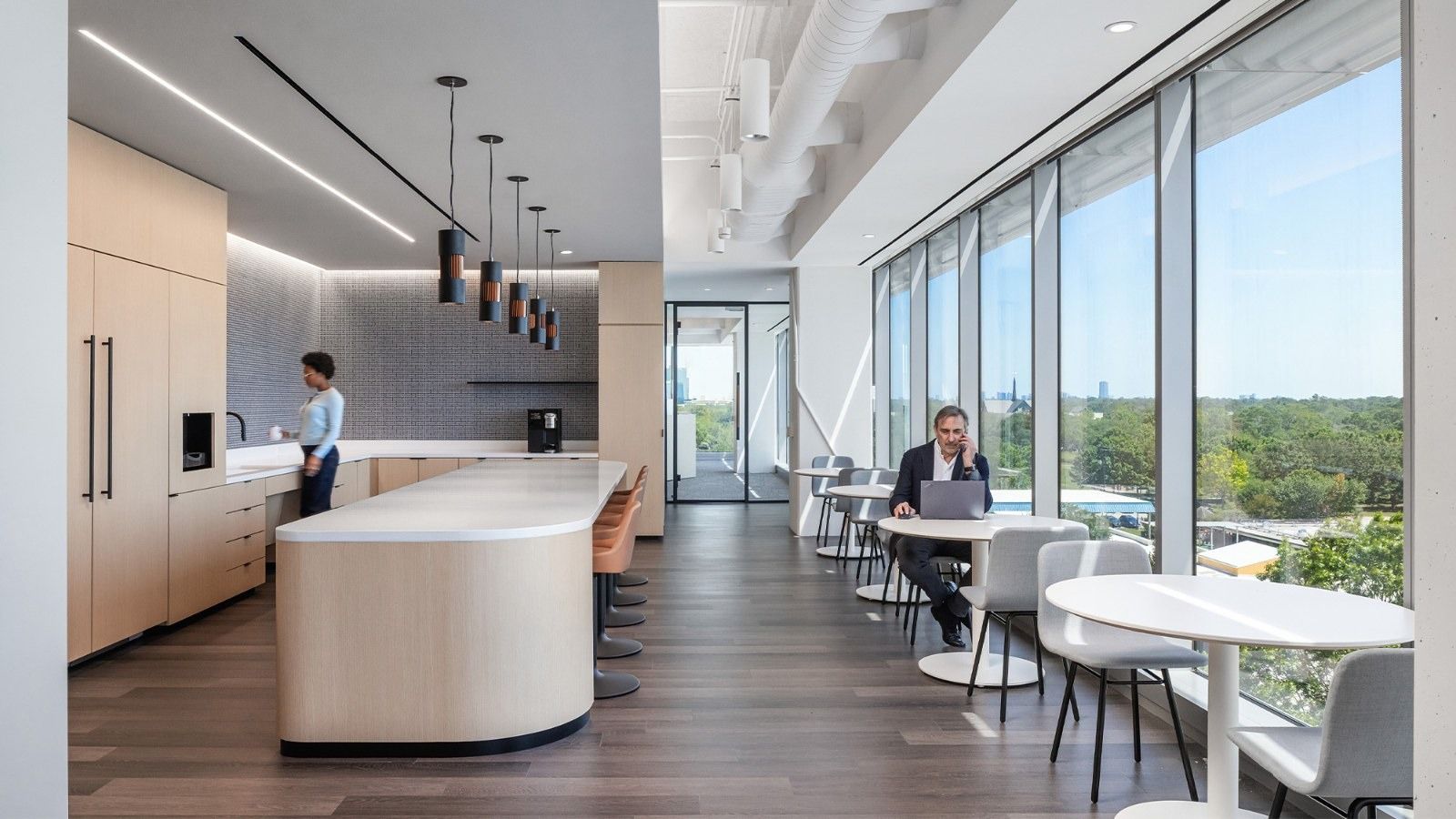 Group 1 Automotive: A café bar beside windows with treetop views