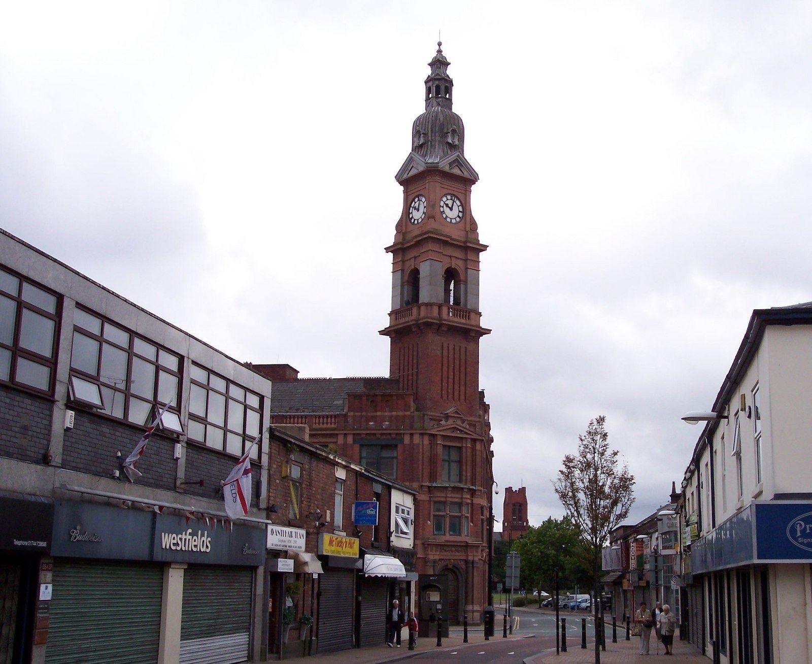 Red-brick clock tower on a shopping street