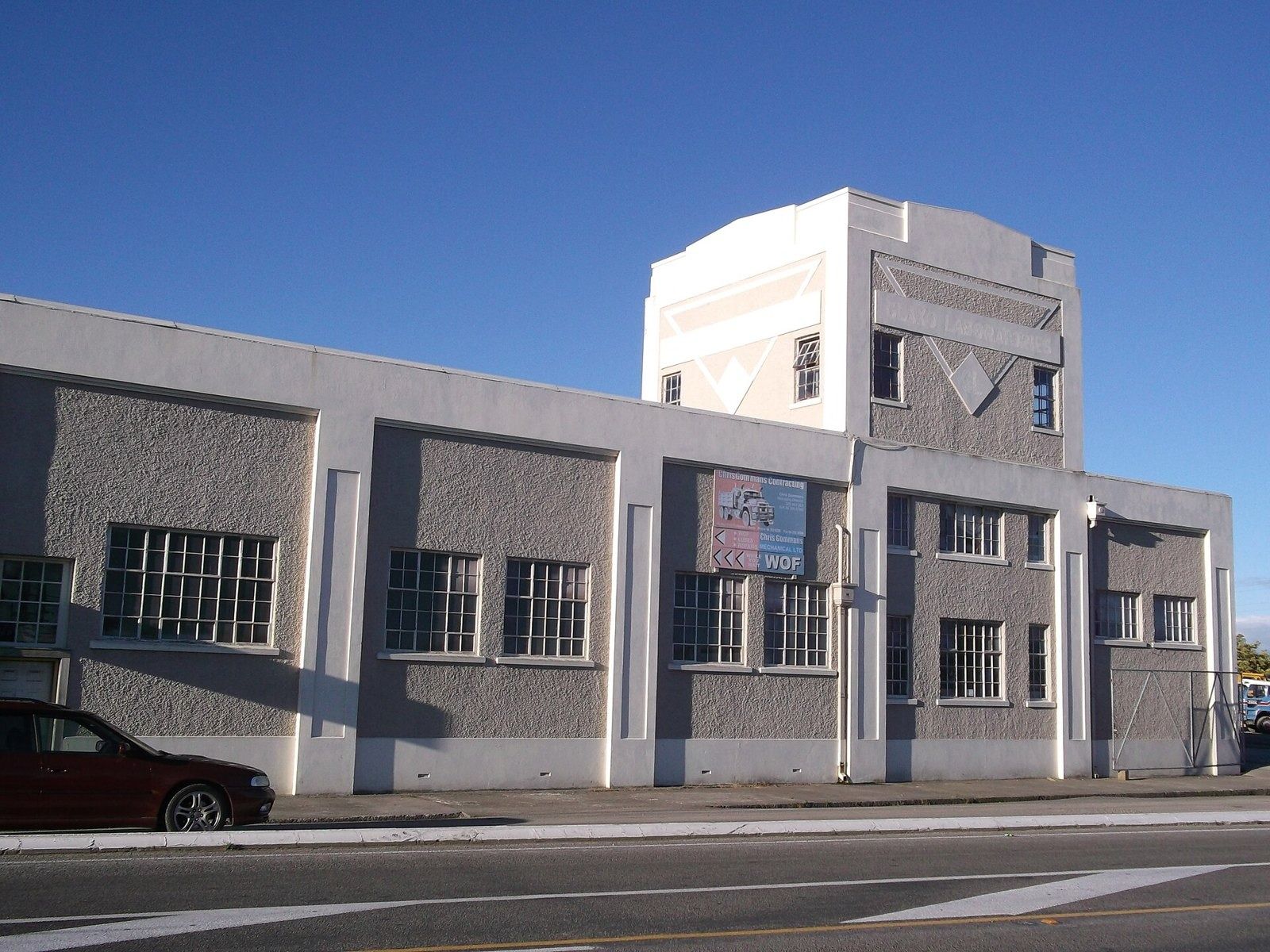 White factory building with a stepped tower