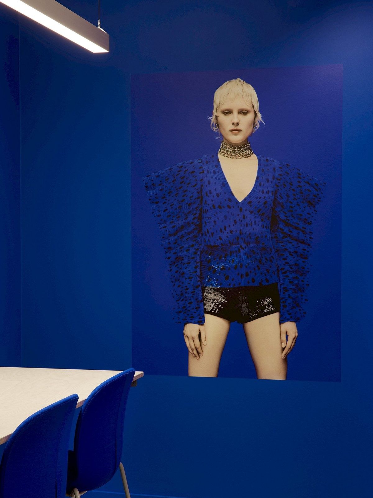H&M Group: Blue wall with a large fashion photograph