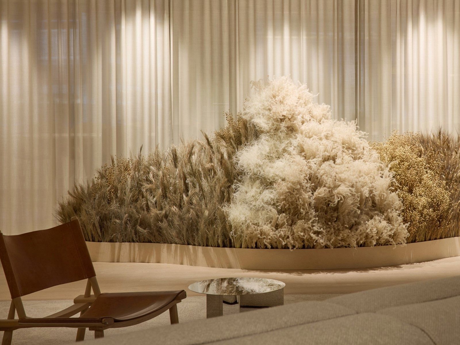 H&M Group: Lounge chair beside a bank of dried grasses