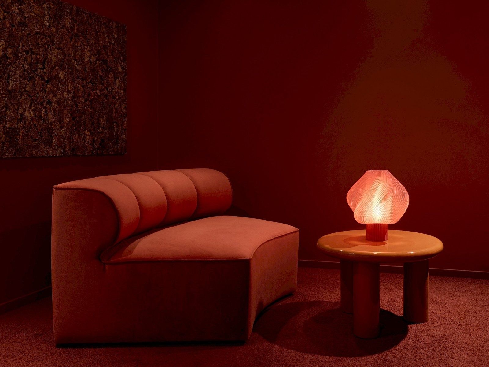 H&M Group: Red room with a curved velvet sofa and glowing lamp
