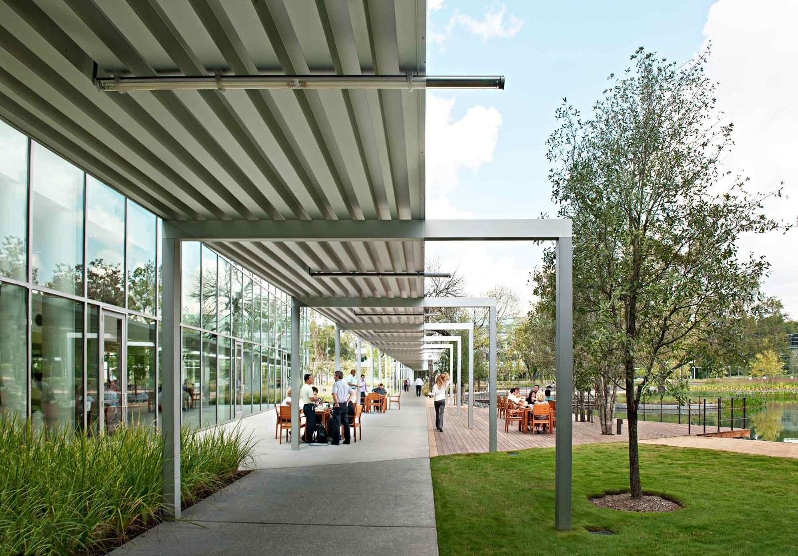 Halliburton: A covered walkway beside glass walls and a lawn
