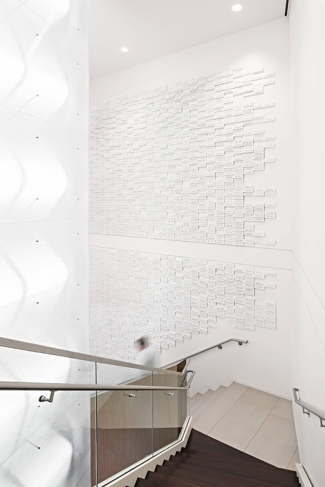 Halliburton: A white sculpted wall beside a stair