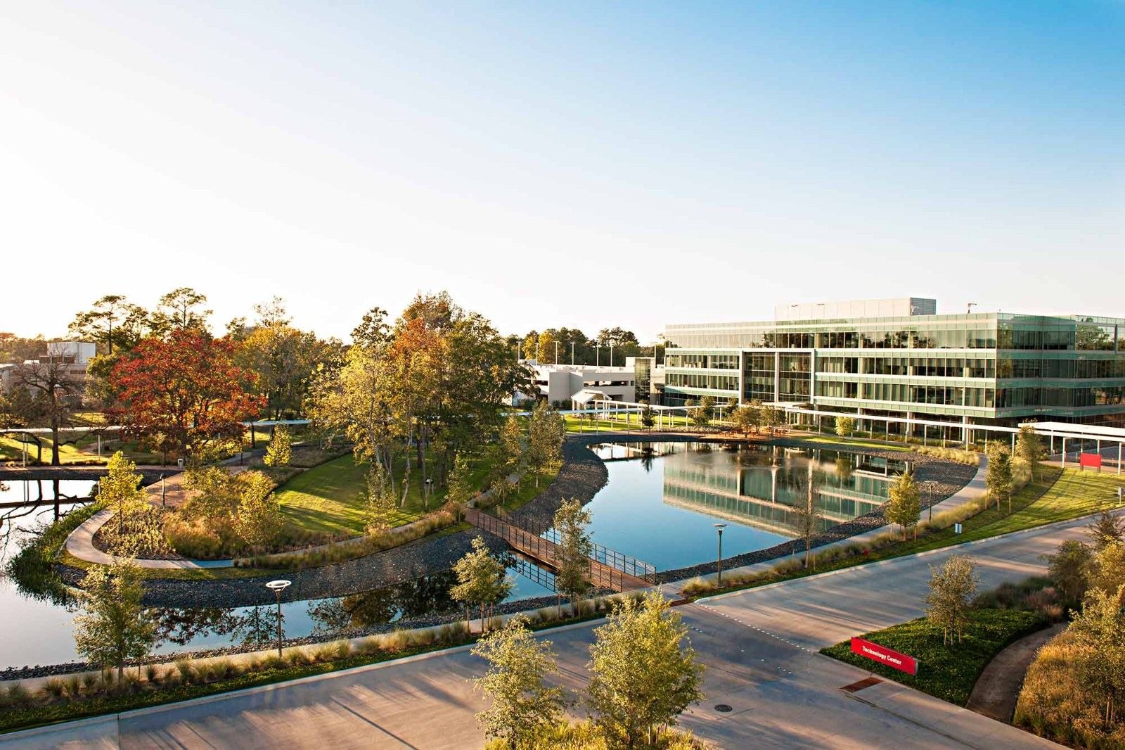 Halliburton: Campus buildings across a pond and trees