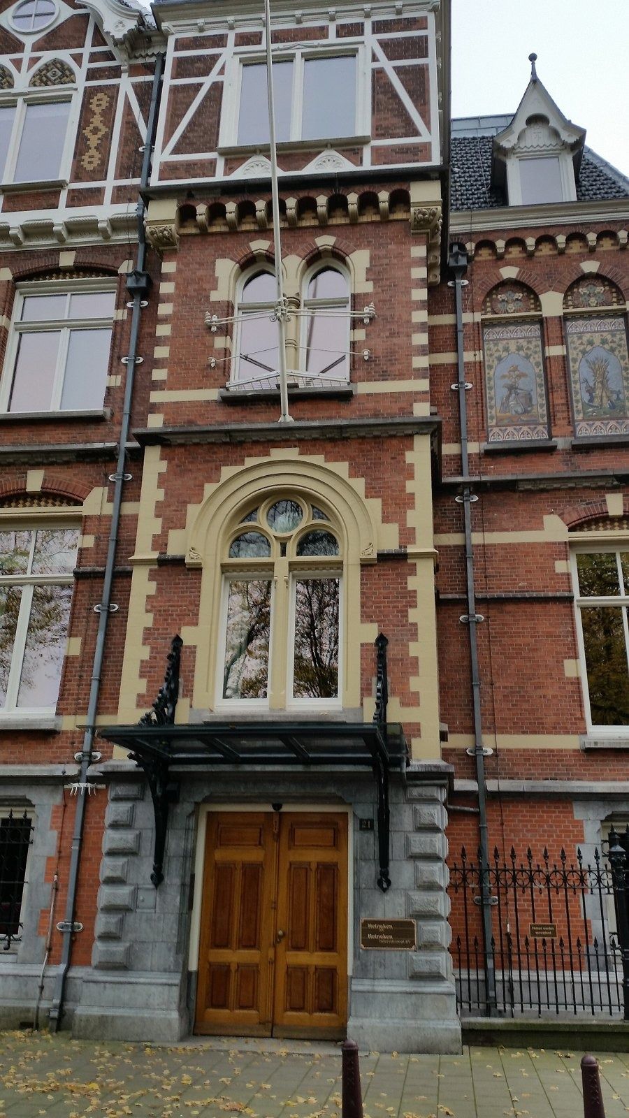 Heineken: Arched wooden entrance door set in an ornate brick facade