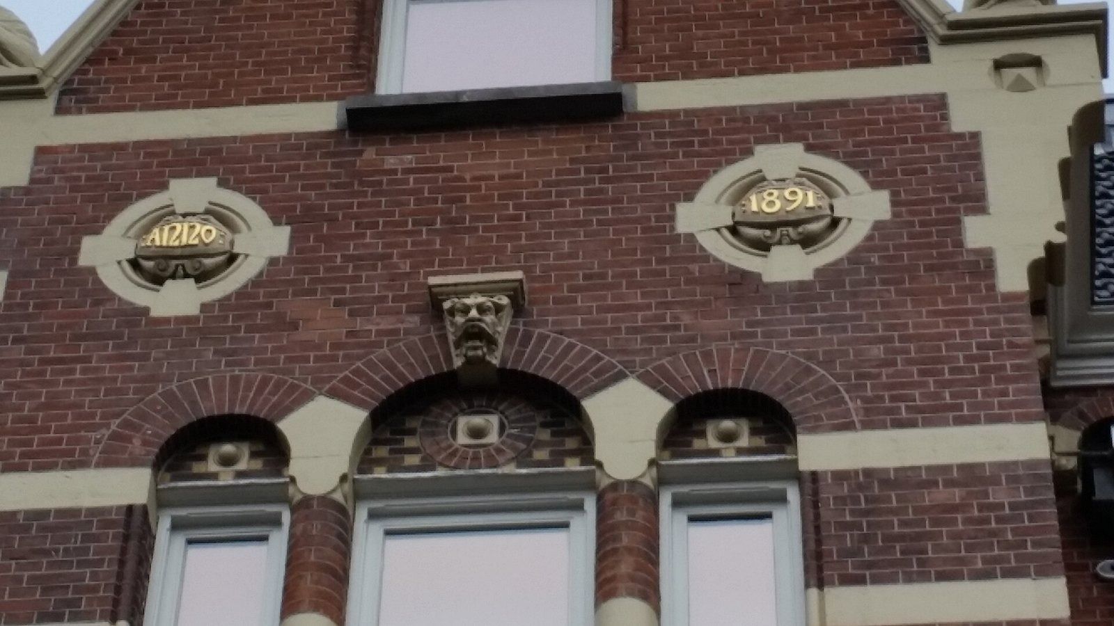 Heineken: Brick facade with two oval date stones above arched windows