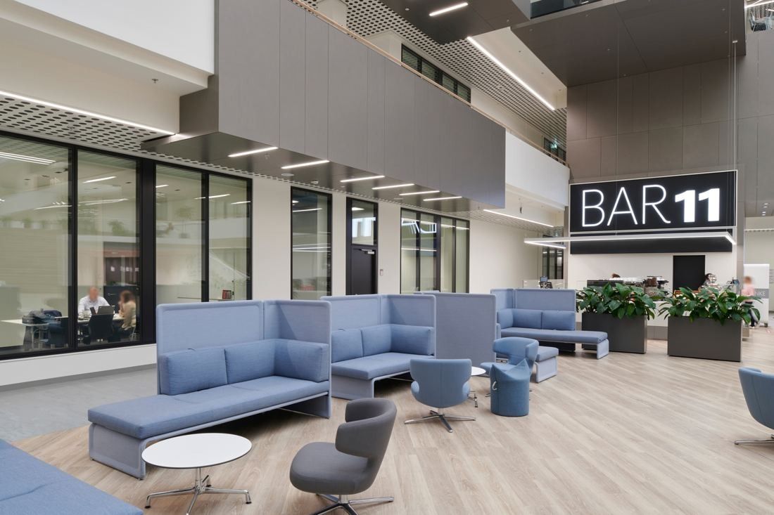 Henkel: Blue upholstered lounge seating next to a café counter