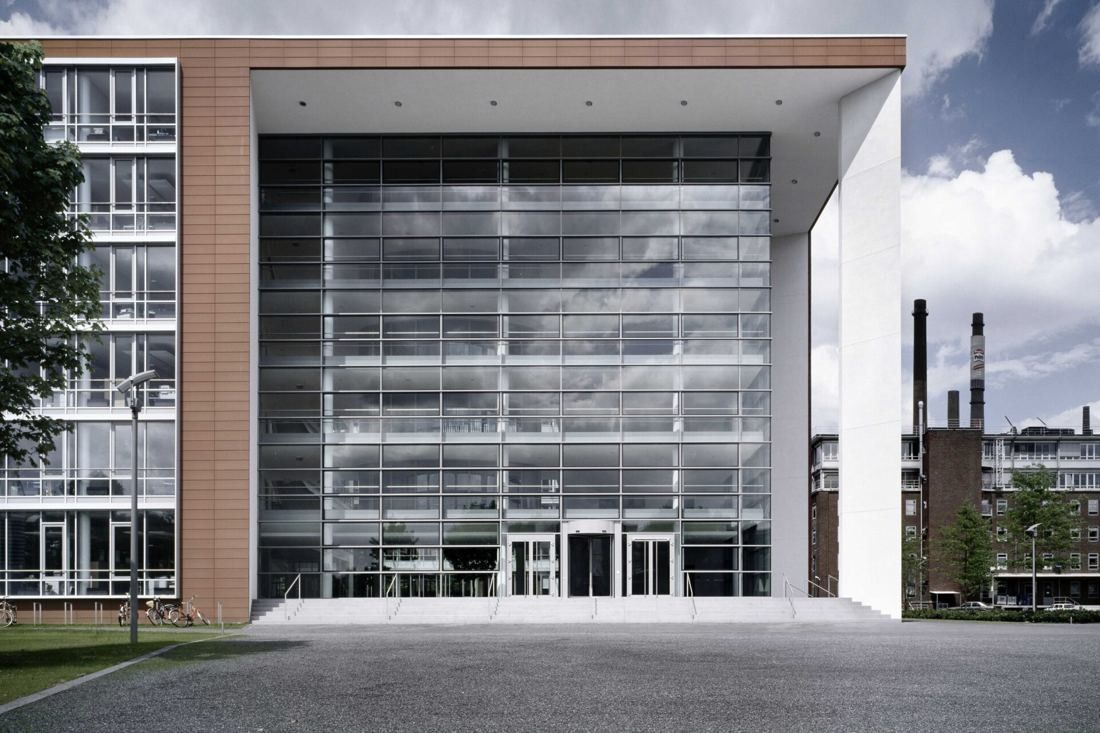 Henkel: Full-height glass entrance facade framed by brick and white walls