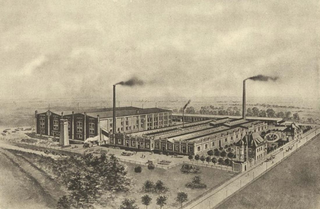 Sepia view of a large factory complex with smoking chimneys