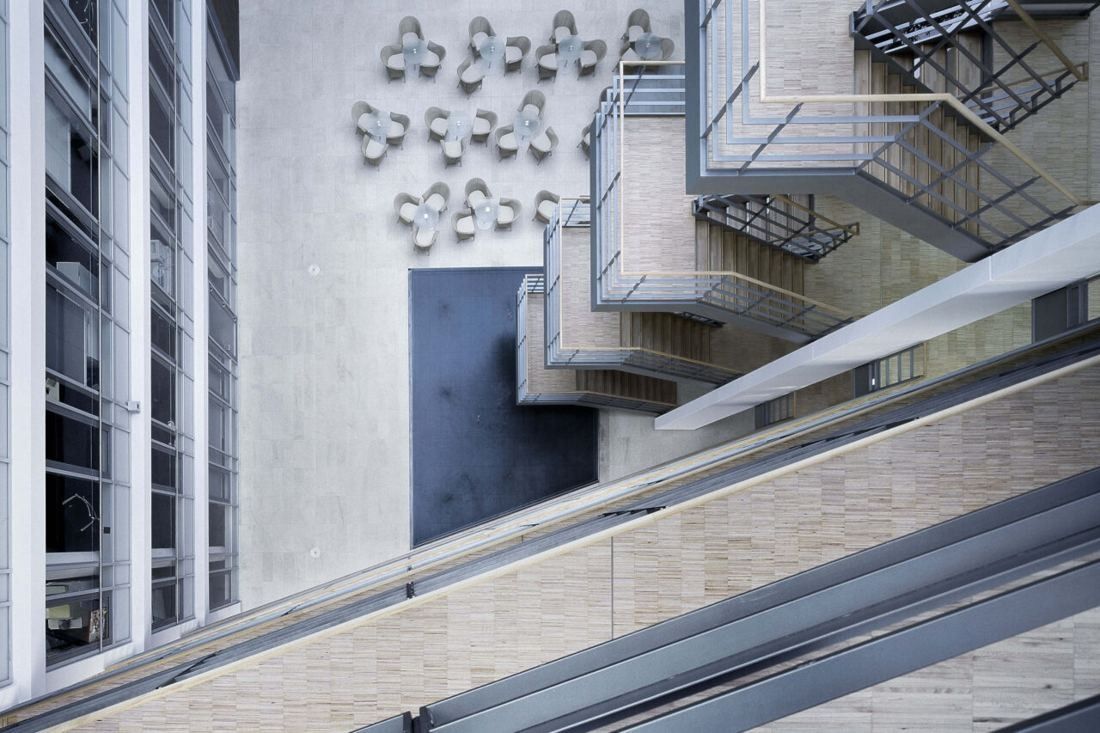 Henkel: Stair landings beside a wall with a sculptural artwork