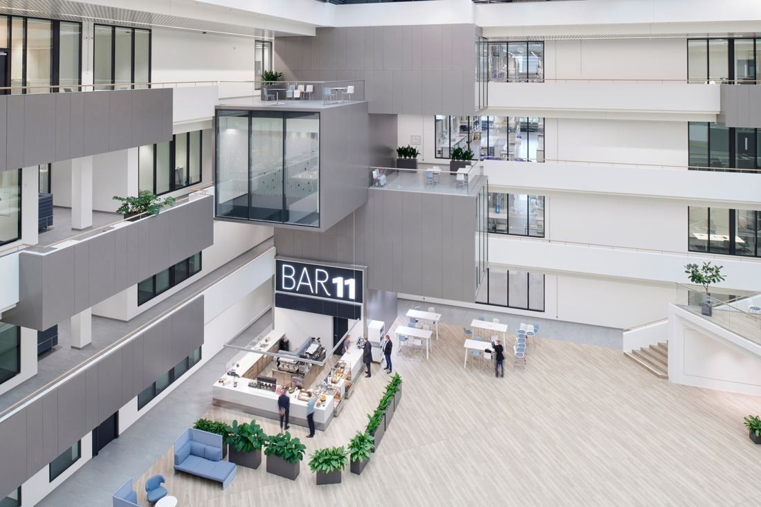 Henkel: View down into the atrium onto a café area, seating and planters