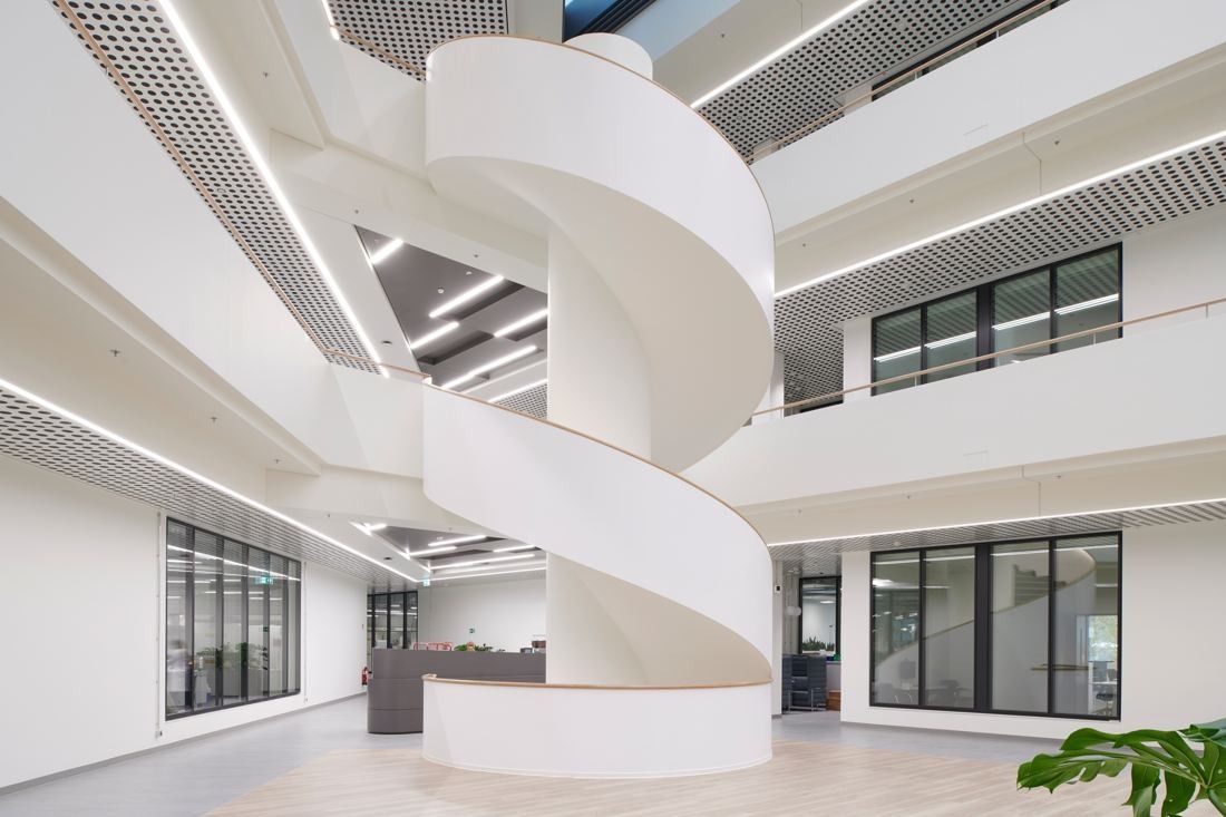 Henkel: White spiral staircase winding between gallery levels