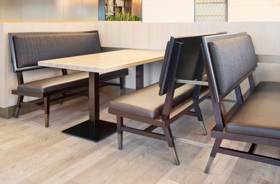 Hilton: Upholstered high-back booths around a light stone table