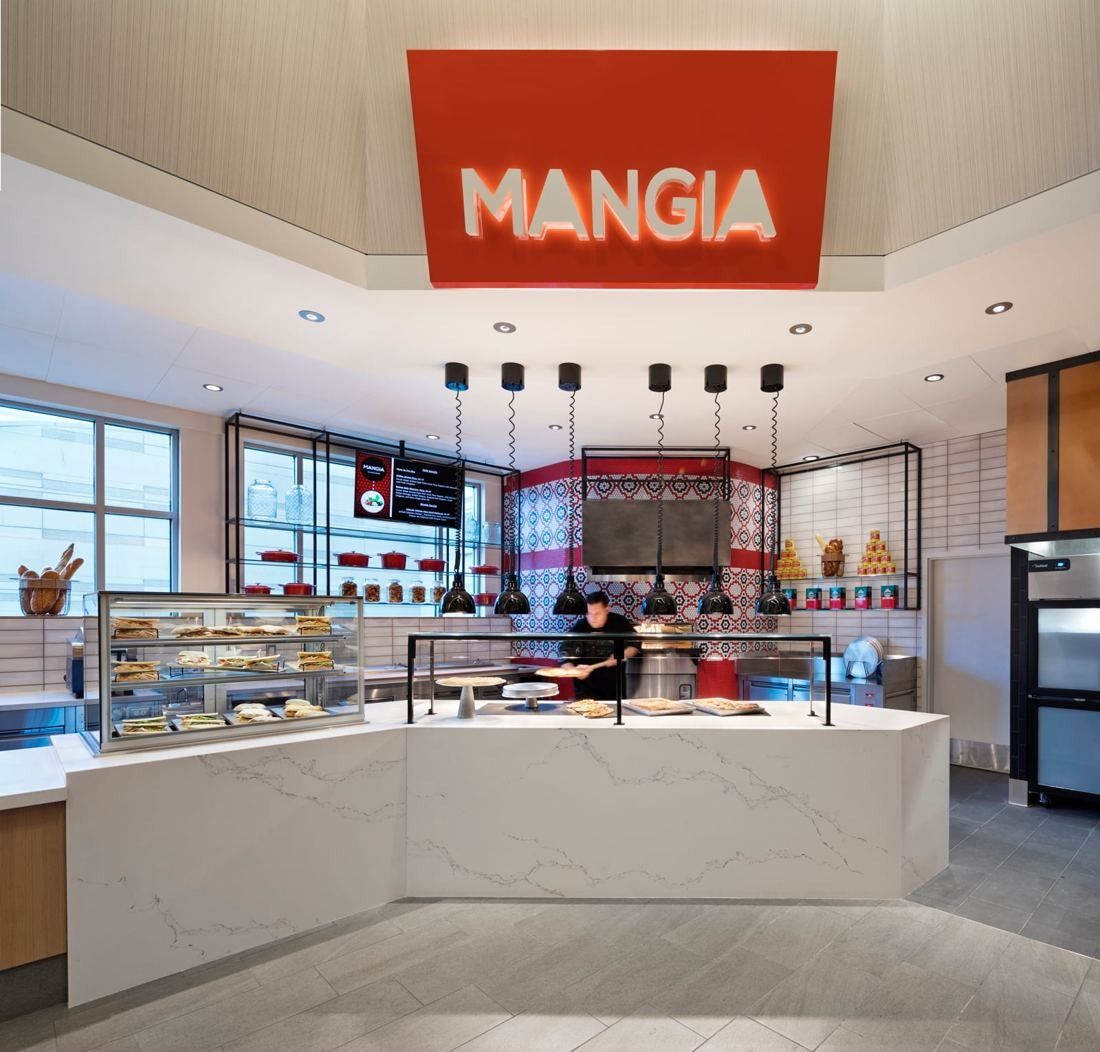 Hilton: White marble counter under a red MANGIA sign with pastry cases