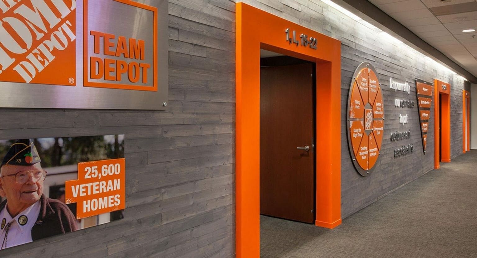 The Home Depot: Corridor with orange door frames and company history graphics