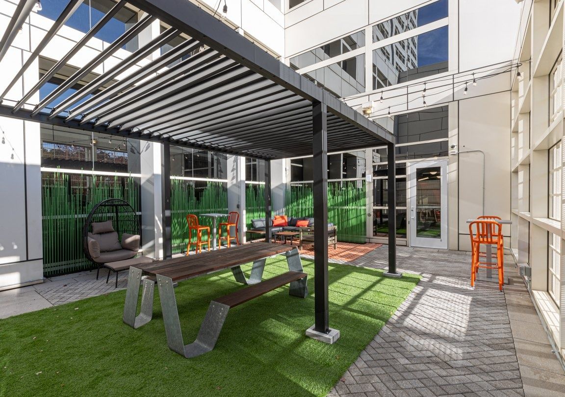The Home Depot: Indoor courtyard with a pergola, turf and picnic tables