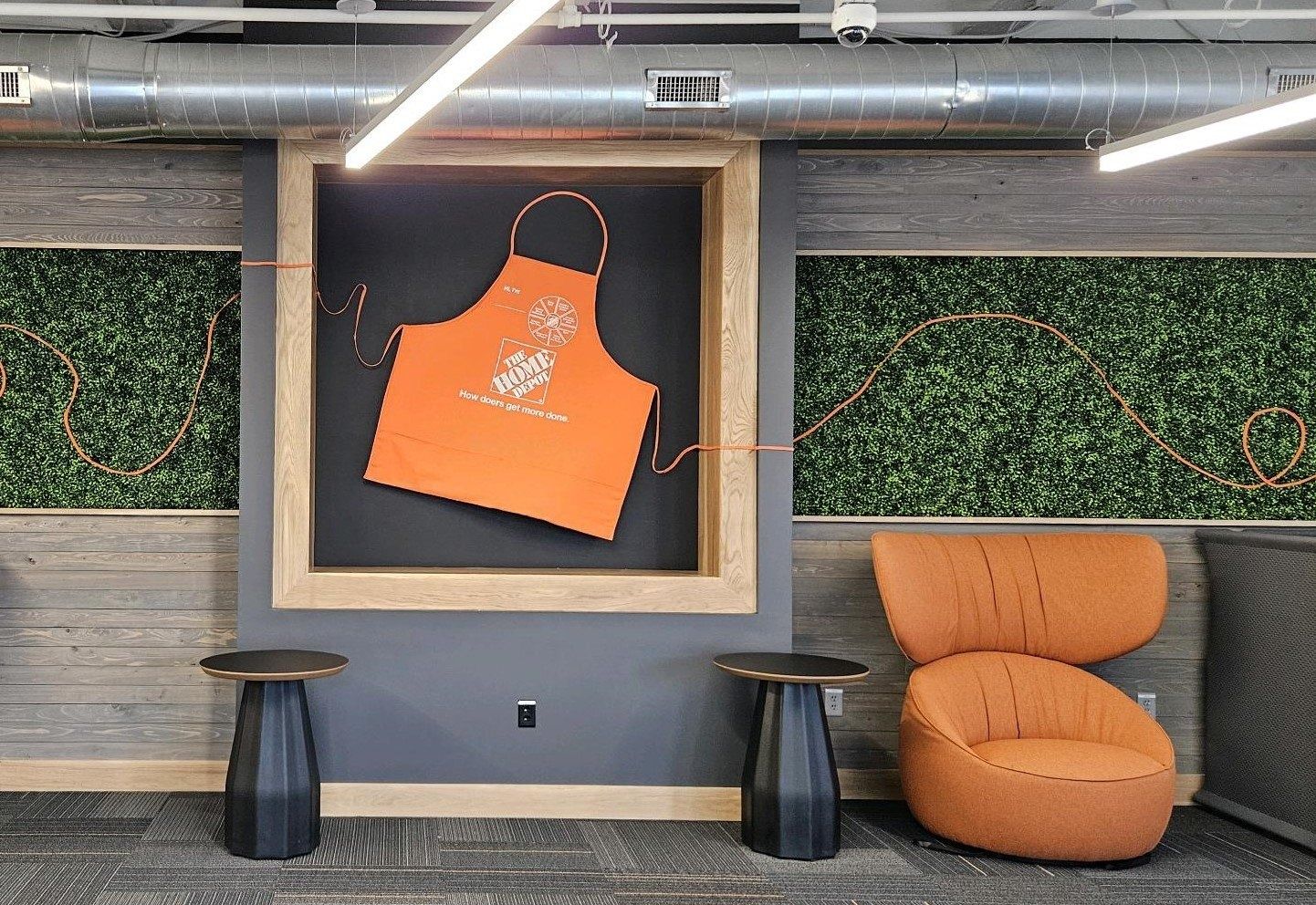 The Home Depot: Lounge with an orange apron framed on a green wall